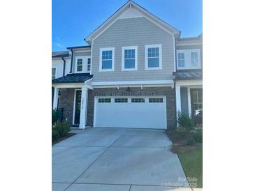 Attractive home featuring a two-car garage, neutral color palette, and architectural details at 10416 Audubon Ridge Dr # 4, Cornelius, NC 28031