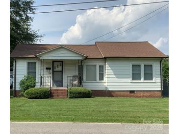 Charming single-story home with white siding, well-maintained lawn, and inviting front porch at 1721 9Th Ne Ave, Hickory, NC 28601