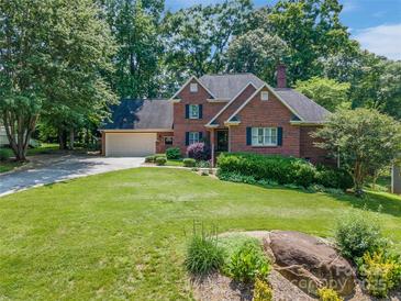 Beautiful brick two-story home with a well-manicured lawn and attached two car garage at 2043 Shadwell Ct, Gastonia, NC 28056