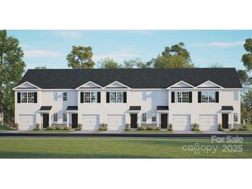 New construction townhome with a white facade, a row of garages, and a lush green lawn at 3136 Ora Smith Rd, Lincolnton, NC 28092