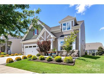 Charming two-story home featuring manicured landscaping, a two-car garage, and inviting front porch area at 5064 Lassen Volcanic Trl, Lancaster, SC 29720
