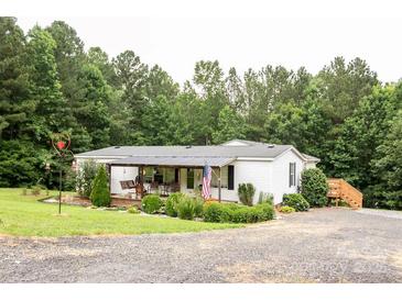 Charming single-story home with a covered front porch and lovely landscaping at 6213 Golden Oak Ln, Denver, NC 28037