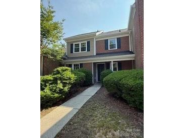 Charming townhome with brick accents, well-maintained landscaping, and inviting entryway at 9125 N Vicksburg Park Ct, Charlotte, NC 28210