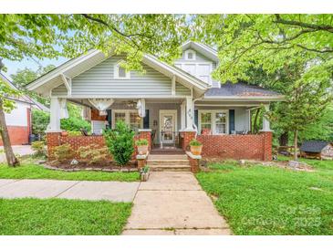 Charming home features a well-manicured front yard and inviting front porch at 153 S Center St, Taylorsville, NC 28681