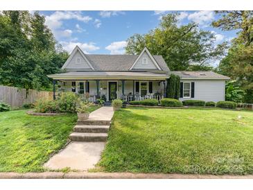 Charming home with a covered front porch, walkway and a well-manicured lawn at 300 S Hudson Ave, Spencer, NC 28159
