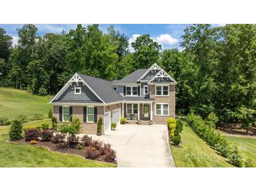 Stately two-story home with brick facade, well-manicured landscaping, and a spacious three-car driveway at 322 Ethan Ln, Rock Hill, SC 29732