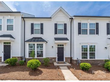 Charming townhome features light siding, dark shutters, manicured landscaping, and welcoming front entrance at 5008 Patton Dr, Gastonia, NC 28056