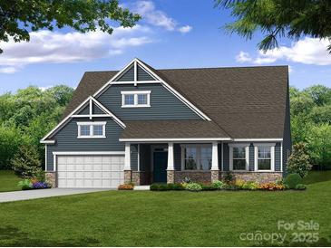Charming craftsman-style home with blue siding, stone accents, a welcoming front porch, and a well-maintained lawn at 5205 Raging Creek Dr # 122, Indian Trail, NC 28079