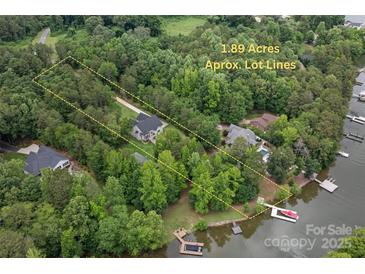 A beautiful aerial view showcasing the approximate lot lines and lake access with dock at 8283 Long Island Rd, Catawba, NC 28609