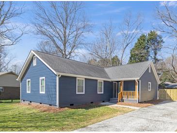 Charming blue home with a well-maintained lawn and inviting front porch at 9930 Sardis Oaks Rd, Charlotte, NC 28270