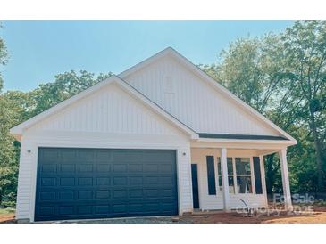 Charming single-Gathering home featuring a dark blue garage door, white siding, and a welcoming front porch area at 118 3Rd Nw Ave, Conover, NC 28613