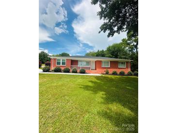 Charming red brick home with a well-maintained lawn, offering classic curb appeal at 1535 Jordan St, Lancaster, SC 29720