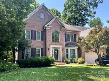 Charming two-story brick home with well-manicured lawn and lovely landscaping in a desirable neighborhood at 17433 Glassfield Dr, Huntersville, NC 28078