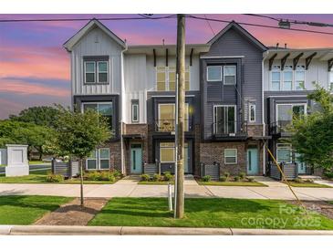 Charming townhome with a modern design, brick accents, and well-manicured landscaping at 223 S Bruns Ave, Charlotte, NC 28208