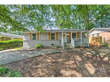 Charming single-story home featuring a welcoming front porch and wood-toned shutters at 3020 Stancill Pl, Charlotte, NC 28205