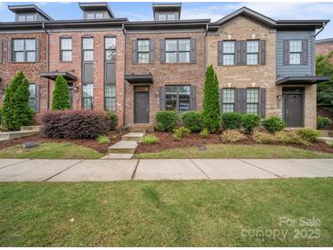 Charming townhome features a brick facade, well-maintained landscaping, and inviting entryway at 416 Linestowe Dr, Belmont, NC 28012