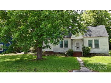 Quaint home featuring a well-maintained lawn and mature trees providing shade and curb appeal at 514 Saluda Rd, Chester, SC 29706