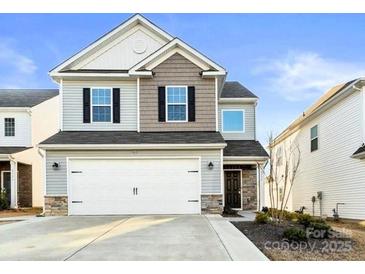 Charming two-story home with a two-car garage and a mix of siding and stone accents at 5775 Soft Shell Dr # 310, Lancaster, SC 29720