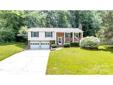 Charming two-story home with a well-maintained lawn, attached two car garage and inviting curb appeal at 5909 Ryder Ave, Charlotte, NC 28226