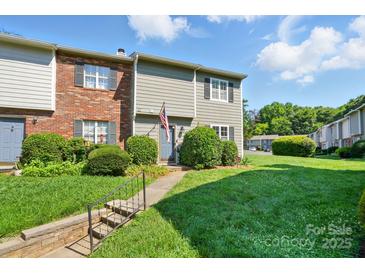 Charming townhouse featuring well-maintained landscaping and a welcoming entrance at 6044 Heath Valley Rd, Charlotte, NC 28210