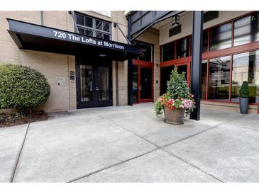 The building entrance at 720 The Lofts at Morrison with flower display and black awning at 720 Governor Morrison St # 221, Charlotte, NC 28211