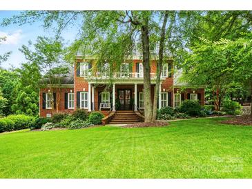 Stately brick home with lush green lawn and mature landscaping, offering timeless elegance at 748 Land Fall Dr, Rock Hill, SC 29732
