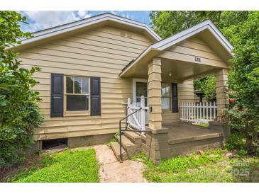 Charming single-story home featuring a covered front porch with decorative white picket fence at 807 3Rd St, Kings Mountain, NC 28086