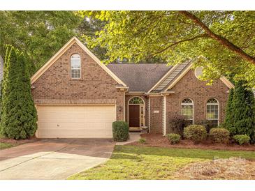 Charming brick home with manicured lawn and attached garage, offering classic curb appeal at 901 Clearbrook Rd, Matthews, NC 28105