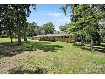 Charming home featuring a welcoming front deck and lush, tree-filled surroundings at 926 Meadow Lakes Rd, Rock Hill, SC 29732