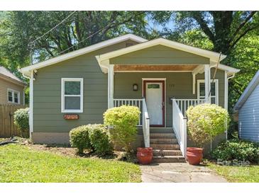Charming bungalow home features a quaint front porch, landscaped yard, and inviting curb appeal at 113 W 5Th Ave, Gastonia, NC 28052