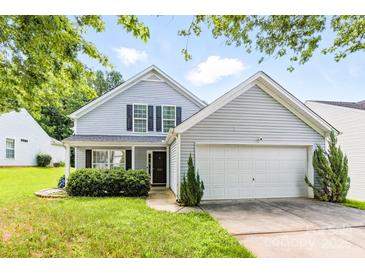 Charming two-story home with light blue siding, black shutters, and a well-manicured front yard at 1515 Kingdom Way, Fort Mill, SC 29707