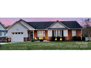 Charming single-story home with brick accents, well-maintained lawn, and inviting front porch at 1700 Pickwick Ave, Kannapolis, NC 28083