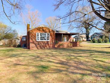 Cozy brick home featuring a front porch and a well-maintained front yard at 176 Travis Loop, Statesville, NC 28625