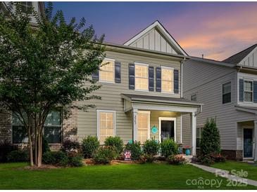 Charming two-story home features a landscaped front yard with lush greenery and a welcoming entrance at 2343 Mt. Harmony Church Rd, Matthews, NC 28104