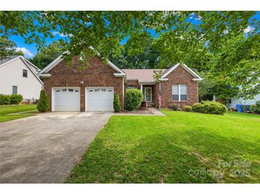 Charming brick home with a well-manicured lawn and a two-car garage at 256 Rose St, Mooresville, NC 28117