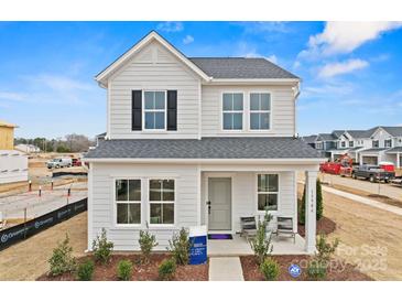 Charming two-story home with gray siding, black shutters, and a welcoming front porch at 15906 Parkside Crossing Dr # 317, Charlotte, NC 28273