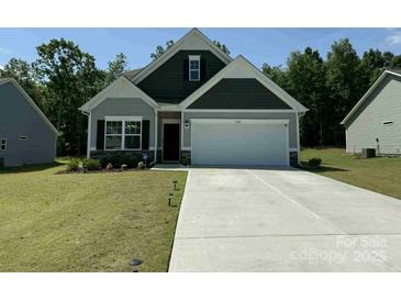 Charming single-Gathering home featuring a two-car garage, well-maintained lawn, and inviting curb appeal at 2921 Parkwest Dr, Albemarle, NC 28001