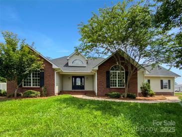 Charming brick home featuring mature trees, well-maintained lawn, and inviting front entrance at 4550 Briarcreek Rd, Maiden, NC 28650