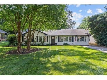 Charming single-story home featuring mature trees, a lush green lawn, and classic curb appeal at 5329 Valley Forge Rd, Charlotte, NC 28210