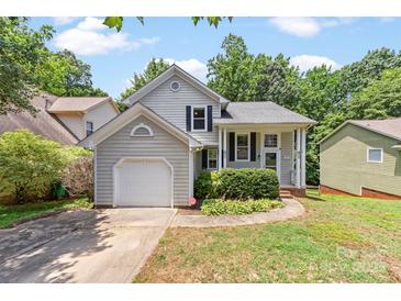Charming single Gathering home with inviting curb appeal, attached garage and lush landscaping at 7425 Hubbard Woods Rd, Charlotte, NC 28269