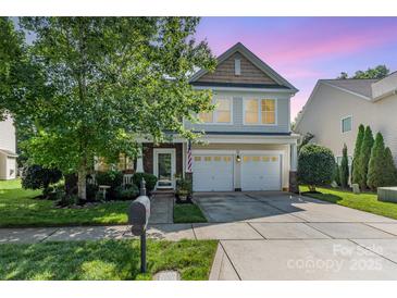Charming two-story home featuring a two-car garage, landscaped yard and inviting front porch at 10237 Broken Stone Ct, Charlotte, NC 28214