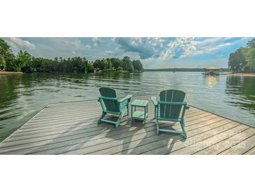 Inviting dock with two Adirondack chairs overlooking the serene lake, perfect for relaxing at 18205 Royal Oak Rd, Charlotte, NC 28278