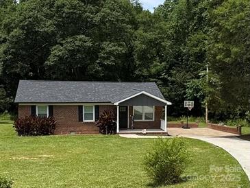 Charming brick home with a well-maintained lawn and a basketball hoop, offering a welcoming curb appeal at 232 Harmony Hills Dr, Catawba, SC 29704