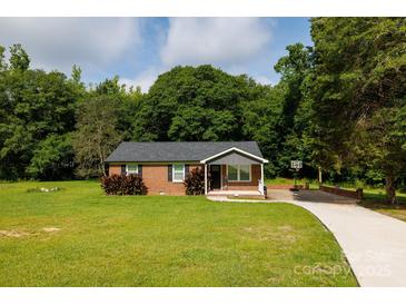 Charming brick home with a well-manicured lawn, complemented by mature trees and a basketball hoop on the driveway at 232 Harmony Hills Dr, Catawba, SC 29704