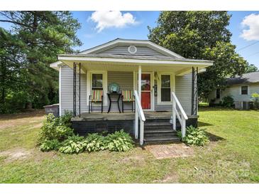 Charming single-story home with a welcoming covered porch and a red front door at 407 Rosemont Ave, Kannapolis, NC 28081