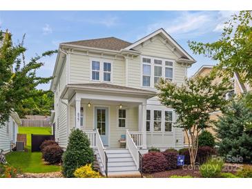 Charming two-story home with a inviting front porch, colorful landscaping, and a well-maintained lawn at 827 Digby Rd, Rock Hill, SC 29730