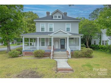 Charming two-story home featuring a welcoming front porch with classic columns and landscaped front yard at 119 Foote St, Chester, SC 29706