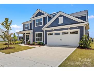 Charming two-story home with a two-car garage, manicured lawn, and beautiful curb appeal at 12205 Hollinhope Dr, Charlotte, NC 28278