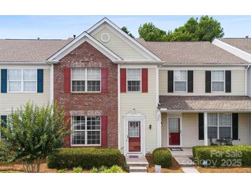 Charming townhome with brick facade, red shutters, and manicured landscaping at 3247 Mannington Dr, Charlotte, NC 28270