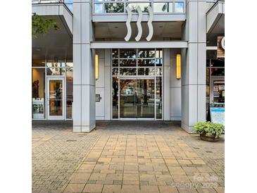Modern building entrance with glass doors and sleek architectural design features at 333 W Trade St # 1106, Charlotte, NC 28202